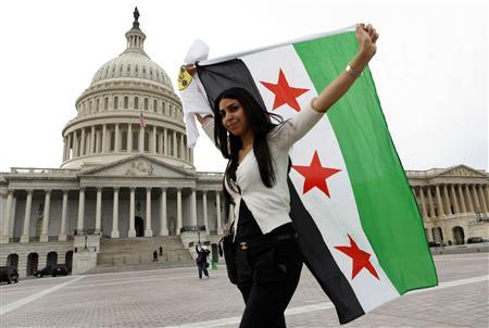 An anti-Assad protester carries the Syrian freedom flag in front of the U.S. Capitol in Washington